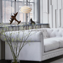 Le Klint Swirl Table Lamp Beside Sofa